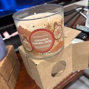 Bath & Body Works Eucalyptus Snowfall and Cinnamon Caramel Swirl Candles.